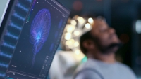 Monitors Show EEG Reading and Graphical Brain Model. In the Background Laboratory Man Wearing Brainwave Scanning Headset Sits in a Chair with Closed Eyes.